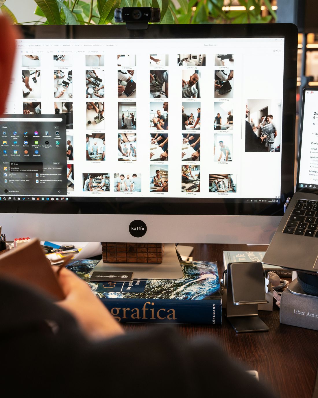 Designer reviewing a grid of campaign photos on a desktop monitor