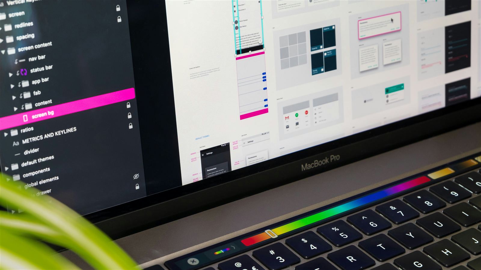 UI UX design file with app screens, components and layers open on a laptop